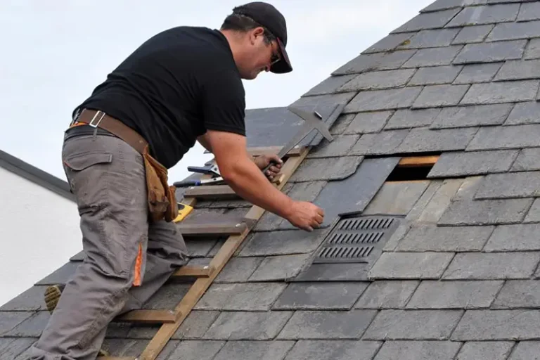 Professional roofer securing reinforced tarp
